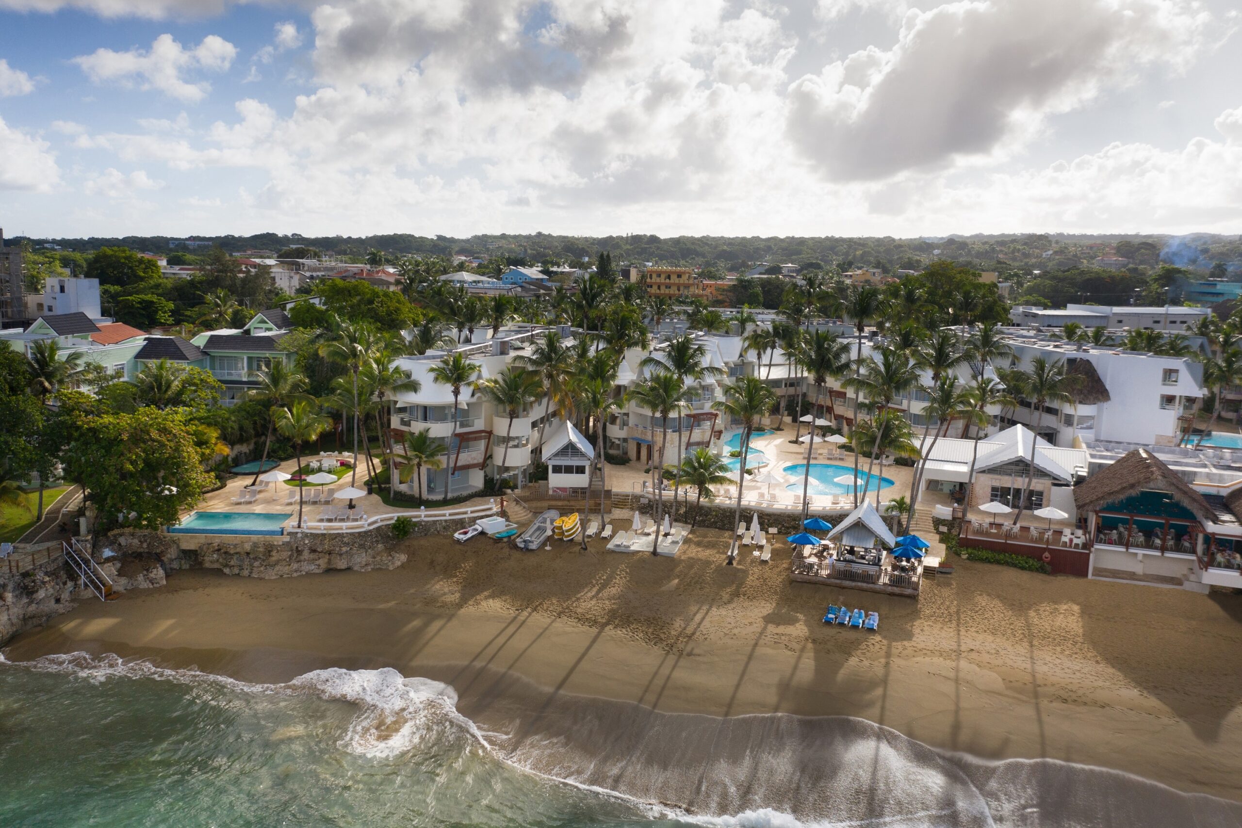 Image of beach, blue water and palm trees