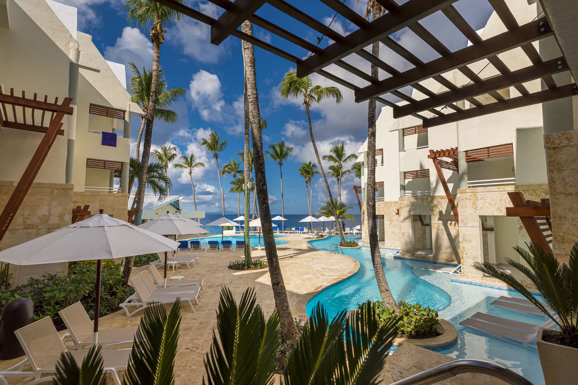 Image of beach, blue water and palm trees